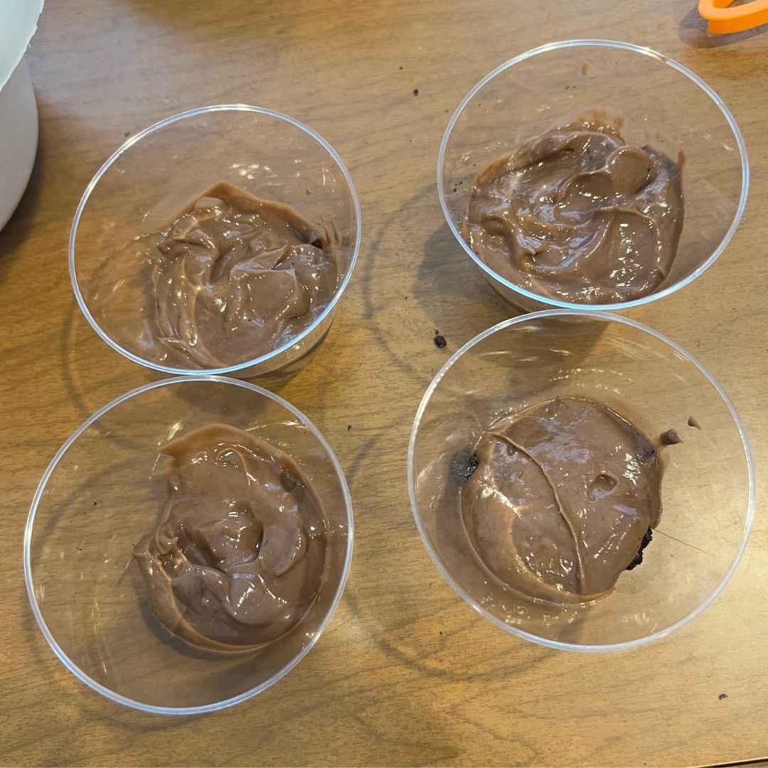 Oreo Dirt Cup Recipe - 4 cups with chocolate pudding in them.
